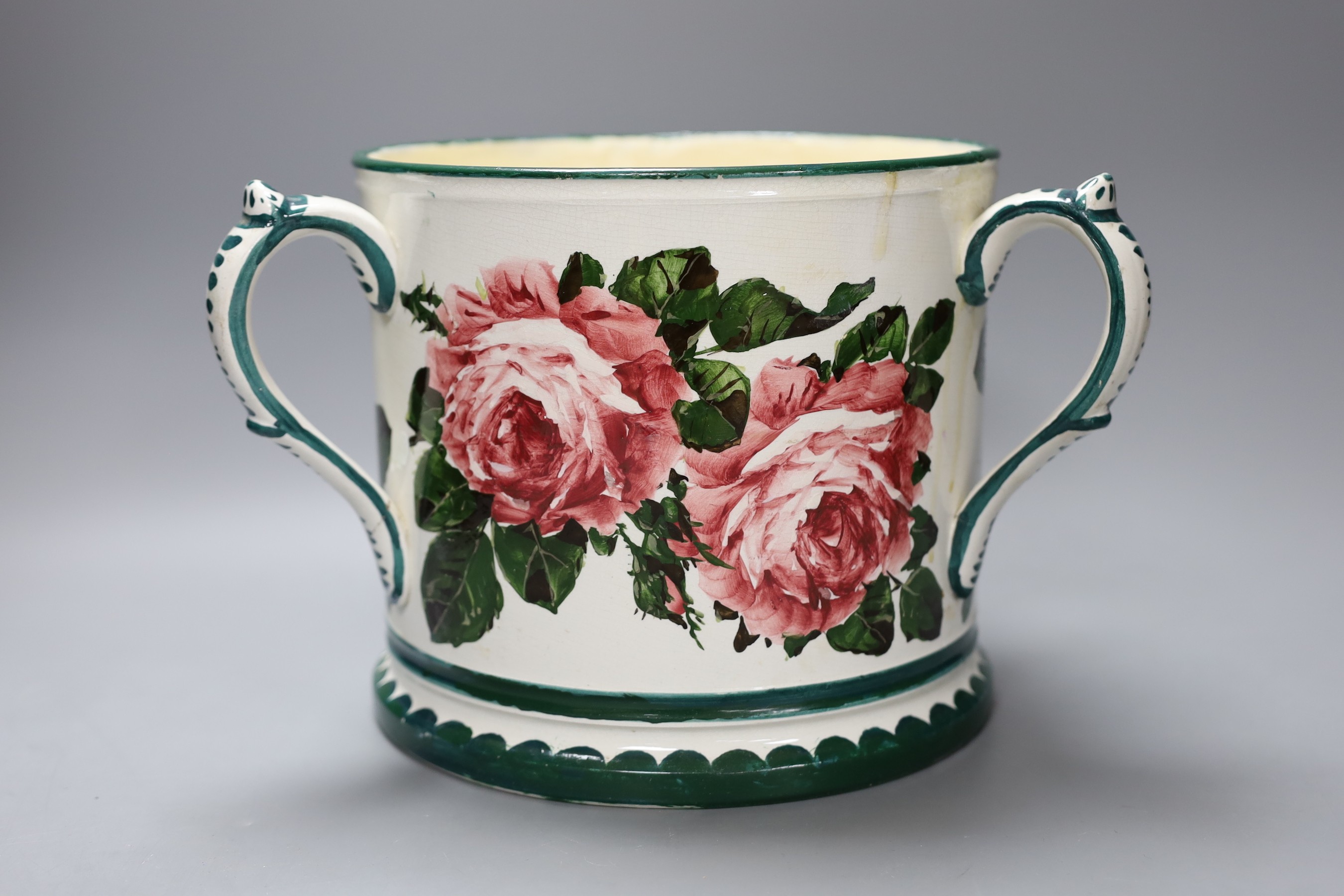 A large Wemyss three handled green and white tankard vase with floral decoration (restored), 19cm tall